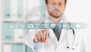 Doctor hand touching medical care text, symbols and icons on virtual screen