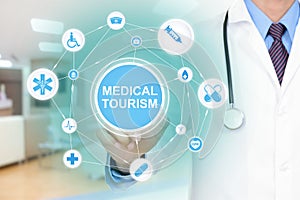 Doctor hand touching MEDICAL TOURISM sign virtual screen photo