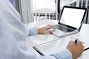 Doctor hand typing on keyboard with blank screen laptop