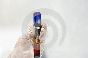 The Doctor hand using syringe sucking medicine from drug vial bottle. photo