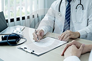 The doctor hand write report and explained the health examination results to the patient, medical checkup concept