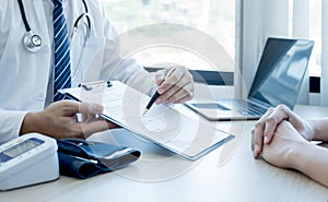 The doctor hand write report and explained the health examination results to the patient, medical checkup concept