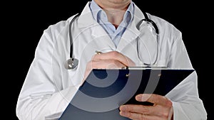 Doctor hand writing on clip board isolated on black background. Close up practitioner hand writing examination at