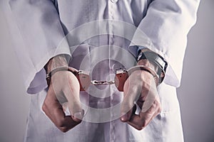 Doctor with handcuffs. Medical crime