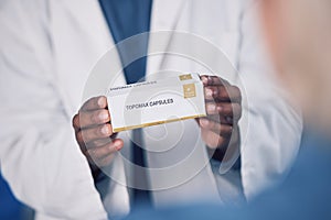 Doctor, hands and box of medication for patient, healthcare or consultation at the pharmacy or clinic. Closeup of male