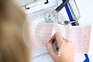 Doctor hands with cardiogram chart on clipboard pad