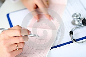 Doctor hands with cardiogram chart on clipboard pad