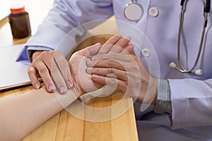 Doctor hands feeling pulse on female wrist