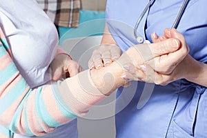 Doctor hands feeling pulse on female wrist, Female doctor measuring blood pulse of senior woman, Hands measuring blood preasure