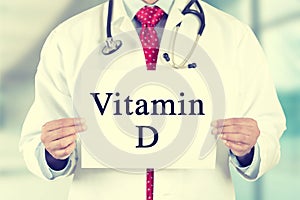 Doctor hands holding white card sign with vitamin D text message