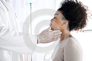 Doctor hands, people and check neck, examine throat or help with vocal injury, tonsils or lymph node. Oral health