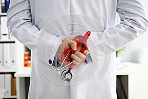 Doctor hands with stethoscope behind his back