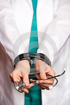 Doctor hands tied by her stethoscope