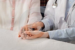 Doctor hands together holding senior woman patient