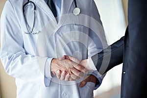 Doctor handshake with a patient