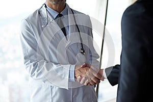 Doctor handshake with a patient