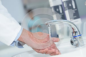 Doctor handwashing in hospital sink