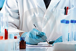 Doctor handwrite a prescription for a drug for a patient in his medical office