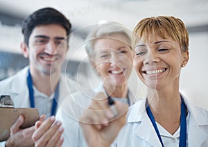 Doctor, happy team and writing healthcare strategy for schedule planning or brainstorming together at hospital. Group of