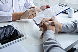 Doctor having conversation with patient while discussing explaining symptoms or counsel diagnosis health and consult treatment of