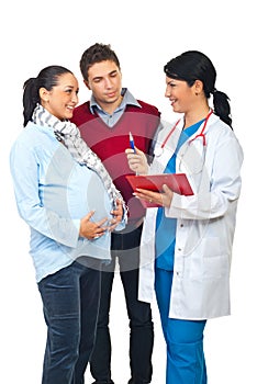 Doctor having conversation with pregnant couple