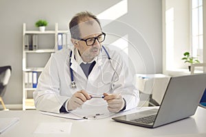 Doctor having online video call remote consultation on laptop at clinic office