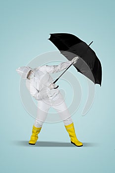 Doctor in hazmat suit posing with umbrella