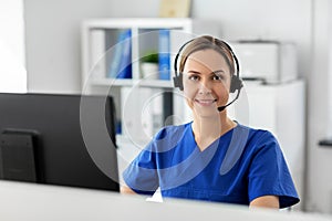 Doctor with headset and computer at hospital