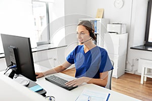 Doctor with headset and computer at hospital