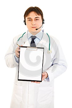 Doctor with headset holding blank clipboard