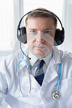 Doctor in headset speaks, talks to patient. Telehealth, telemedicine, online consultation, video call conference. Medical concept