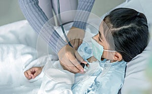 Doctor heal patien asian kid on hospital bed
