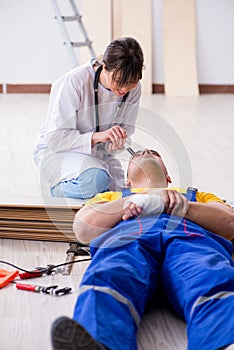 The doctor helping injured worker at construction site