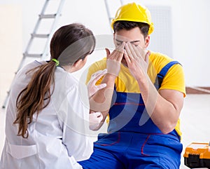 Doctor helping injured worker at construction site