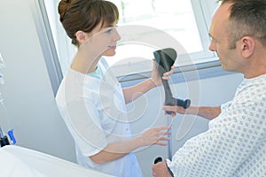 Doctor helping patient with crutch