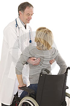 Doctor helping patient to get out the wheelchair