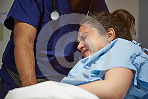 Doctor helping woman in pain