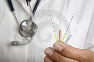 Doctor holding acupuncture needles