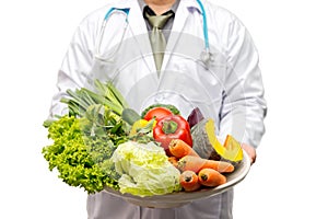 Doctor holding basket assort fresh vegetables isolated on white background