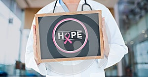 Doctor holding a blackboard with a breast cancer awareness ribbon