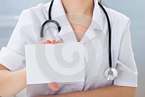 Doctor holding blank card