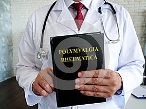 Doctor is holding a book about the polymyalgia rheumatica disease.