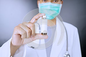 Doctor holding a bottle with copy space photo