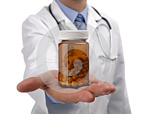 Doctor holding bottle of pills