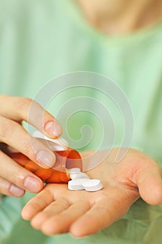 Doctor holding bottle of prescription pills