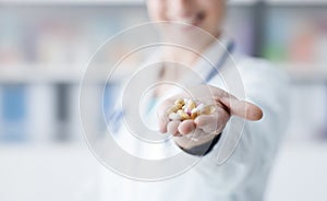 Doctor holding a bunch of pills