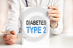 Doctor holding card in hands and pointing the word DIABETES TYPE 2. Medical concept