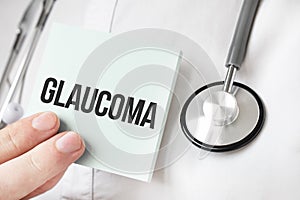 Doctor holding card in hands and pointing the word GLAUCOMA