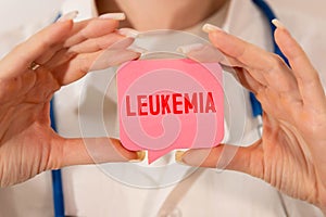 Doctor holding card in hands and pointing the word LEUKEMIA