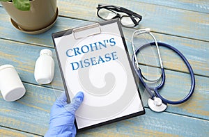 Doctor holding a card with text Crohn's disease photo